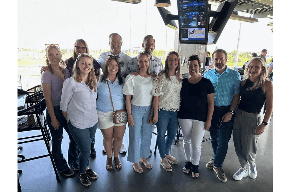 Flywheel team standing together at top golf outing